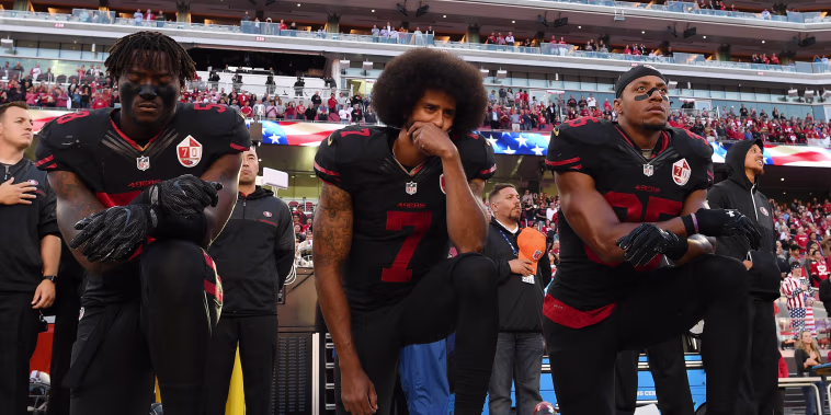Image: Eli Harold, from left, Colin Kaepernick, and Eric Reid of the San Francisco 49ers kneel in protest during the national anthem