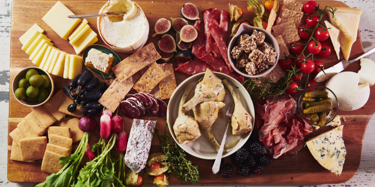 A graze board of meat, cheese, fruit, vegetables and other snacky things