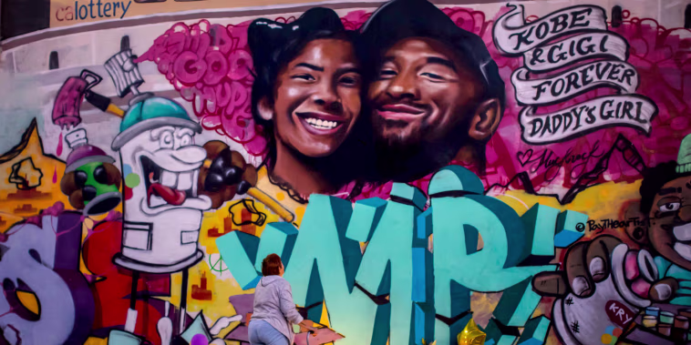 Image: A woman looks at a mural by artists Muck Rock and Mr79lts of Kobe Bryant and his daughter, Gianna, after they were killed in a helicopter crash in Los Angeles on Jan. 27, 2020.