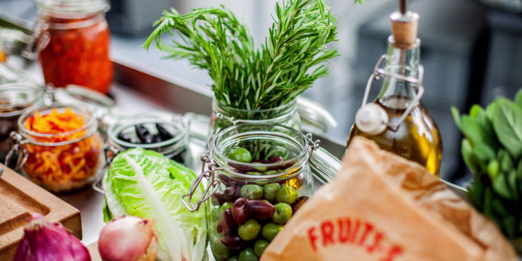 Different ingredients, green olives in glass