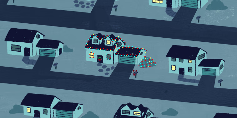 Image: Rows of streets show dark houses with one lit up in Christmas lights.
