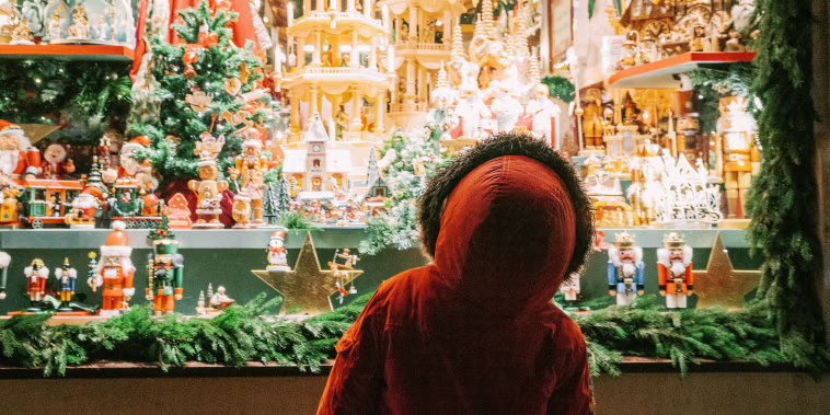 Little boy looking at store window on Christmas
