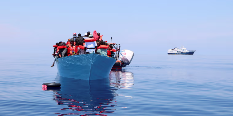 Image: Members of the Doctors Without Borders rescue migrants from a boat in the Mediterranean Sea