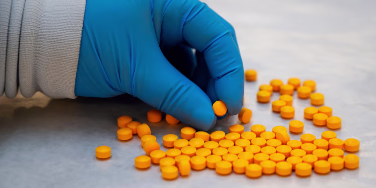 Image: A Drug Enforcement Administration chemist checks confiscated pills containing fentanyl at the DEA Northeast Regional Laboratory on Oct. 8, 2019 in New York.
