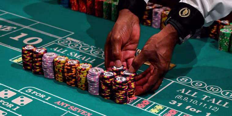A craps dealer prepares stacks of chips at Caesars Palace on the Las Vegas Strip on June 4, 2020.