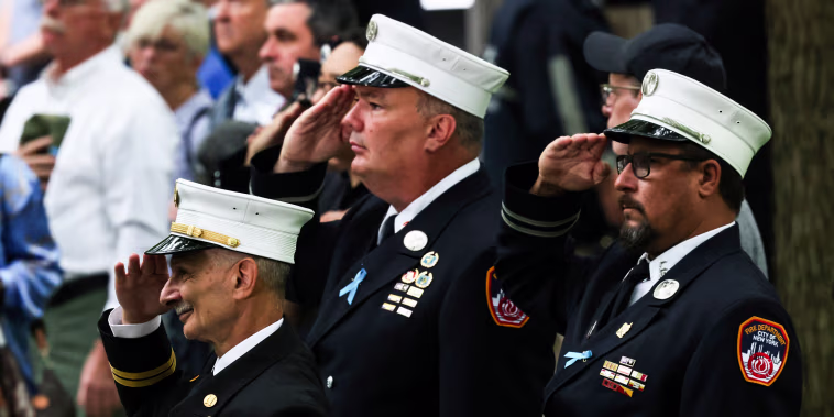 Firefighters salute during the singing of the National Anthem at the annual 9/11 Commemoration Ceremony on Sept. 11, 2022, in New York.