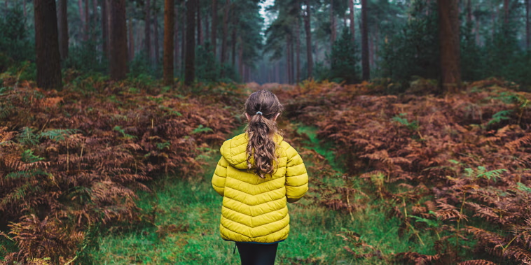 Young girl on forest path
