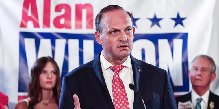 Alan Wilson speaks at a podium