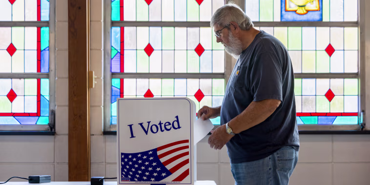 A man casting his ballot at a polling location.