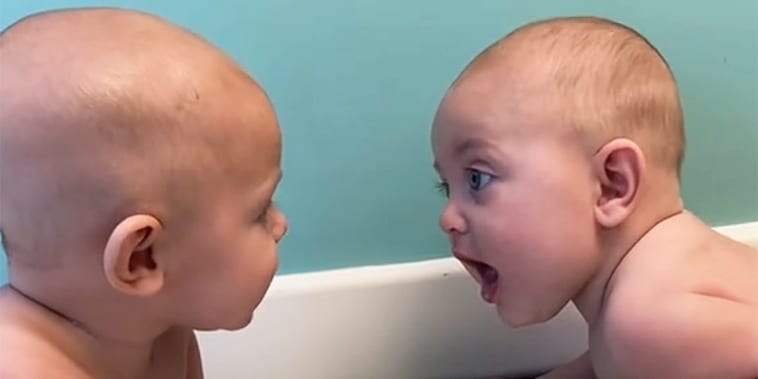 Watch the moment these baby twins notice each other — and chat — for the first time
