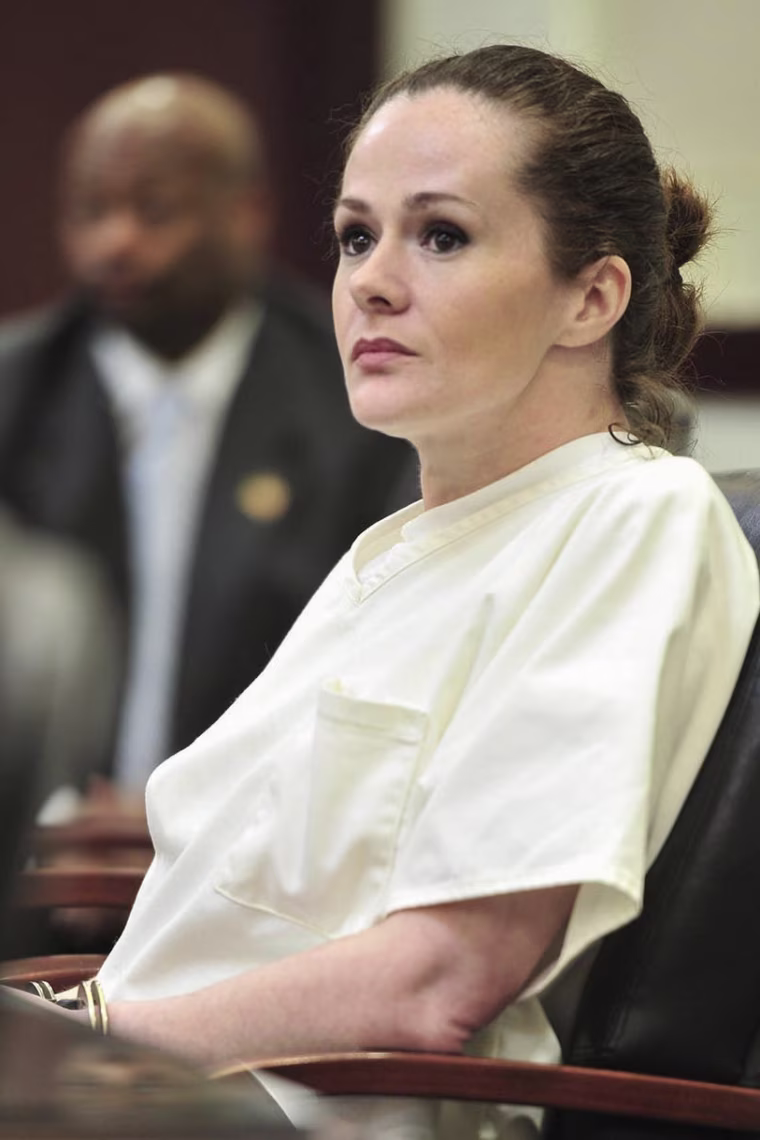 Christa Pike seated in court wearing handcuffs.