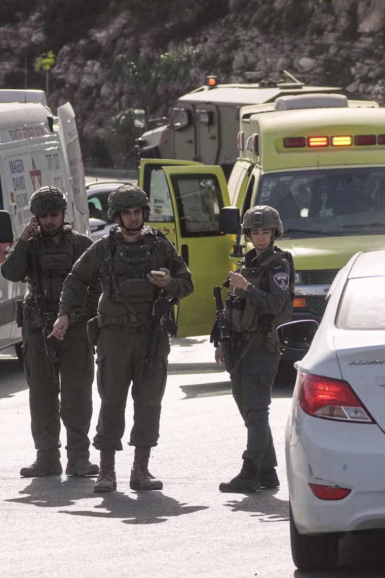 Image: Israeli soldiers and emergency personnel gather near ambulances