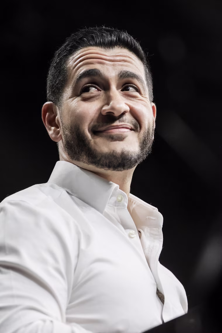 Abdul El-Sayed smiles while on stage at a rally.