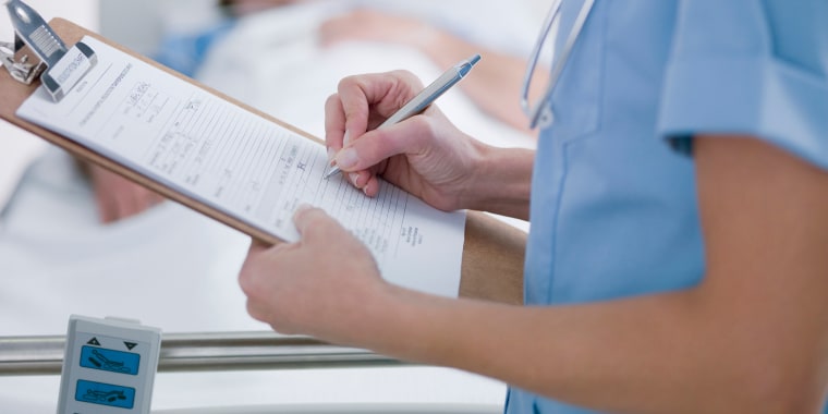 Nurse tending patient in intensive care