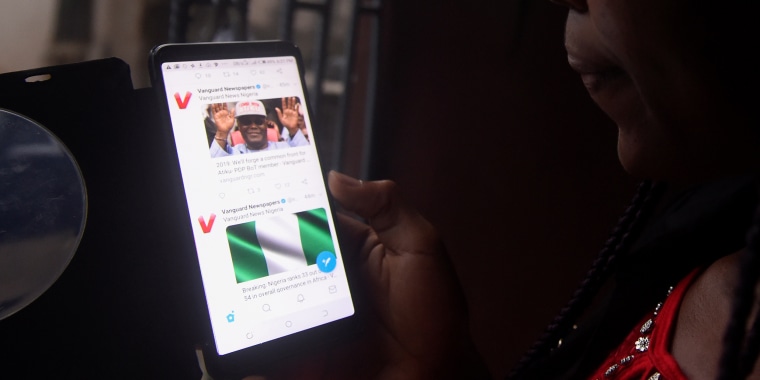 Image: A woman tries to tweet on a smartphone in Lagos on Oct. 29, 2018.