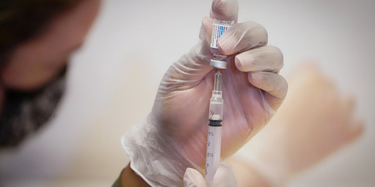 Healthcare worker prepares Johnson & Johnson vaccination dose
