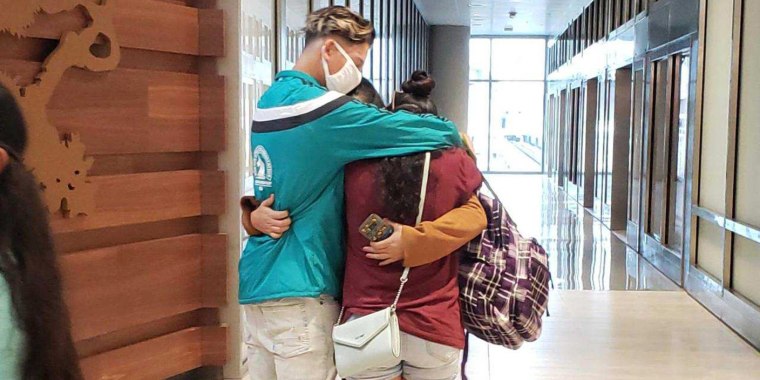 Yudissa hugs her son and daughter on Sunday in the airport in Tampa, Fla., where they reunited after years spent apart.