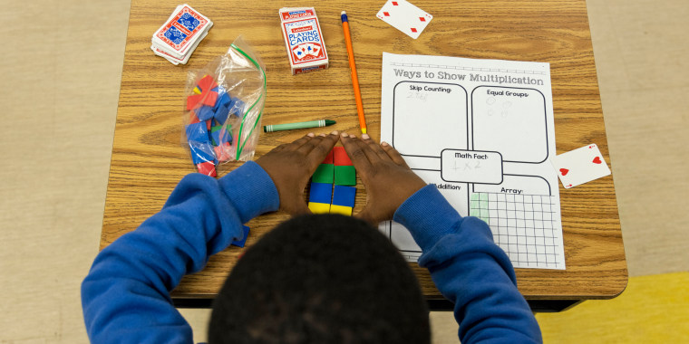A student uses tiles while working on a multiplication problem at Ida Green Elementary.