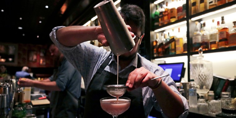 A mixologist crafts a cocktail at a bar, in Boston in 2019.