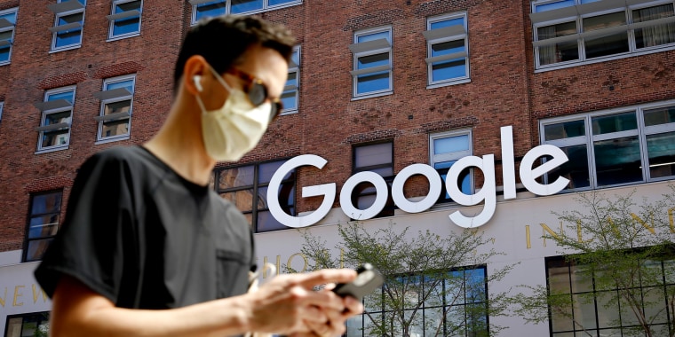 A man checks his phone near a Google Corporate Office on April 13, 2021 in New York.