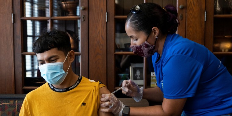 Image: Dr. Melissa Pluguez Moldavskiy, Co-Medical Director of Unidos Contra COVID, administers a vaccine during an outreach event for the Latino community in Upper Darby, Penn., on Aug. 22, 2021.