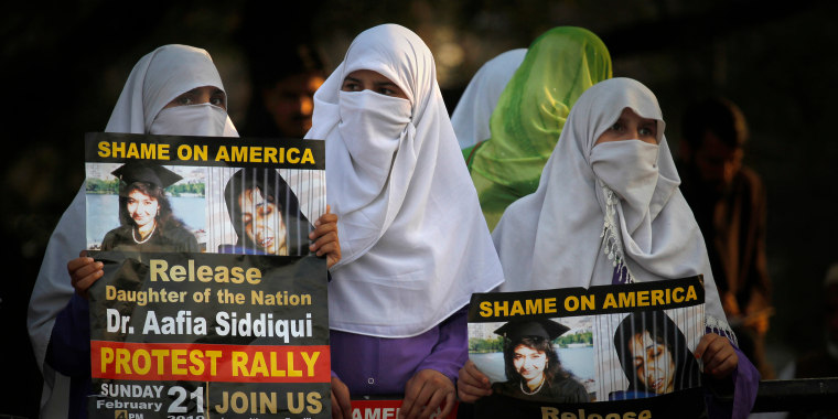 Women hold posters of Aafia Siddiqui during a 2010 rally in Islamabad, Pakistan, demanding her release in 2010.