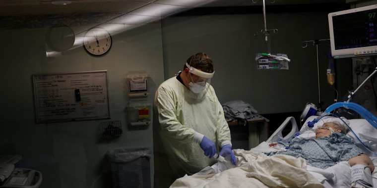 Image: Medical staff treat a patient who has Covid-19 in an isolation room on the Intensive Care Unit (ICU) at Western Reserve Hospital in Cuyahoga Falls, Ohio, on Jan. 5, 2022.