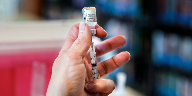 A nurse with Northern Light Health fills a syringe with a Pfizer Covid-19 vaccine dose at a vaccine clinic at Memorial Middle School in South Portland, Me., on Nov. 19, 2021.