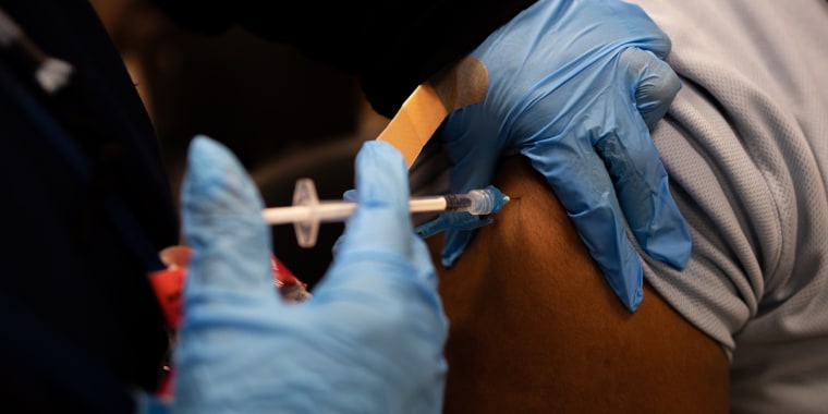 A health worker administers a Covid-19 vaccination in Philadelphia on Dec. 20, 2021.