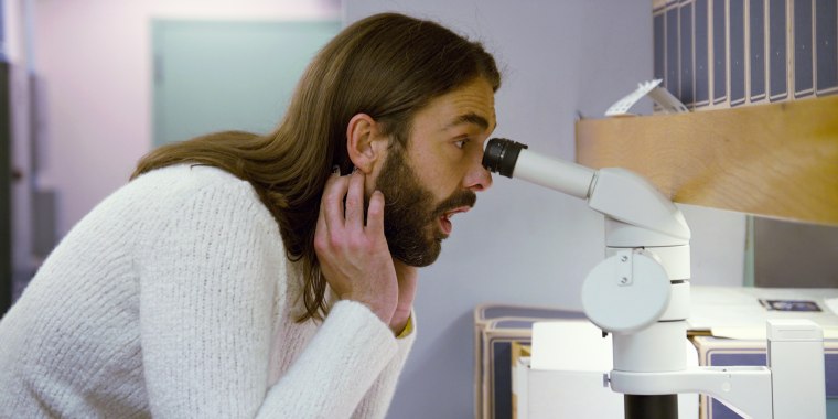 Jonathan Van Ness looks through a microscope in the fourth episode of Netflix's "Getting Curious with Jonathan Van Ness."