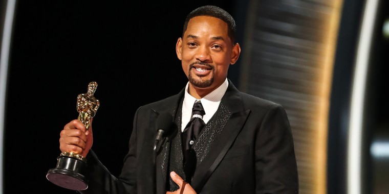 Will Smith accepts the award for best performance by an actor in a leading role for "King Richard" at the Oscars on Sunday in Los Angeles.