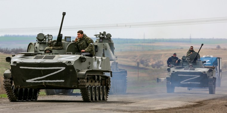 Russian military vehicles move on a highway in an area controlled by Russian-backed separatist forces near Mariupol, Ukraine, on April 18, 2022.