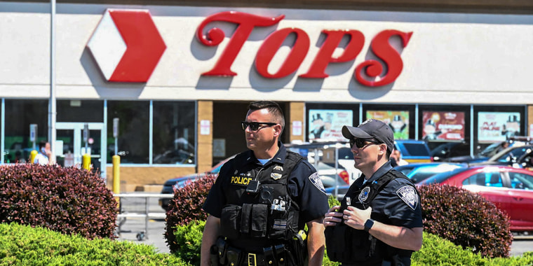 Police stand in front of a Tops grocery store in Buffalo, N.Y., on May 15, 2022.