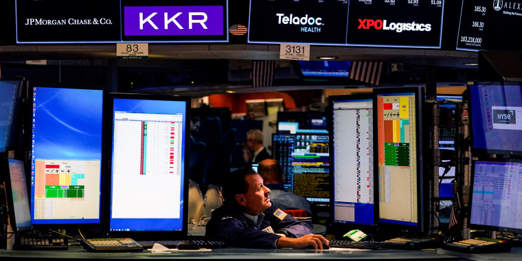 Traders work on the floor during the opening bell of the New York Stock Exchange on May 16, 2022.