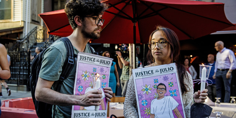 People hold signs for a vigil commemorating Julio Ramirez in New York on June 8, 2022, who died mysteriously after leavig a gay bar in April.