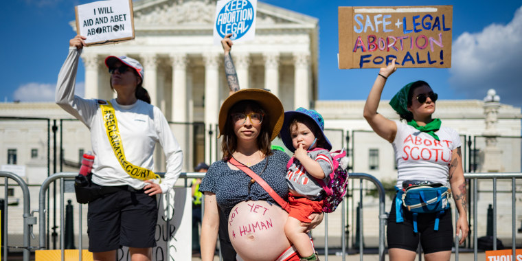 Image: Abortion rights demonstrator Amanda Herring and her 1-year-old son Abraham outside the Supreme Court on June 24, 2022.