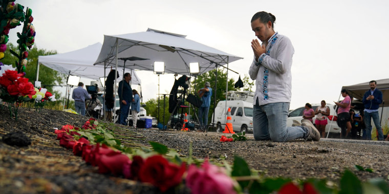 Un hombre reza en el lugar donde las autoridades encontraron a medio centenar de migrantes muertos dentro de un camión, el martes 28 de junio de 2022, en San Antonio, Texas.