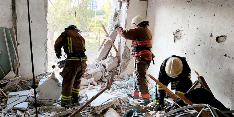Rescue workers sift through the rubble after an apparent missile strike by Russian forces hit an apartment building in Odesa, Ukraine, early on Friday morning.