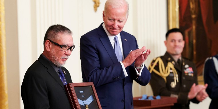 John Kaneshiro accepts the Medal of Honor for his late father, Army Staff Sergeant Edward N. Kaneshiro, as President Joe Biden posthumously awards it, during an event in the White House on July 5, 2022.