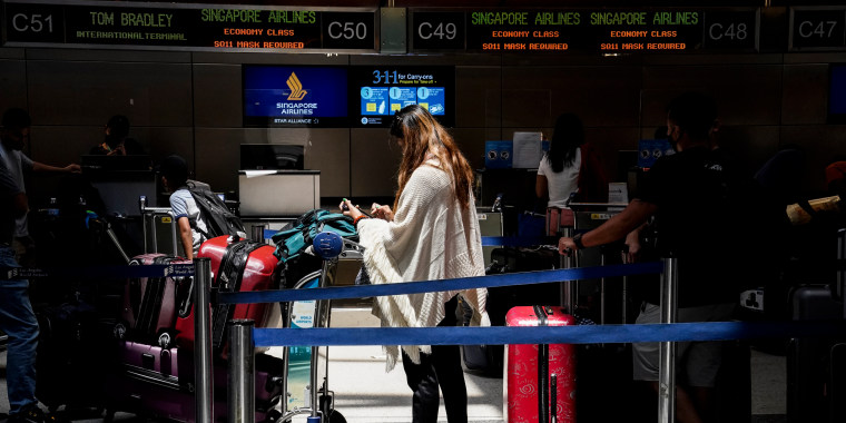Image: A traveler waits for a flight on July 1, 2022 at LAX in Los Angeles.