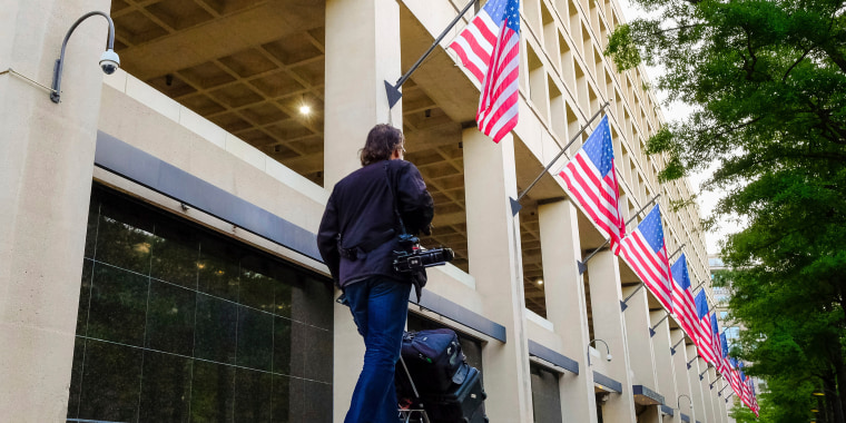 A person walks in front of the FBI headquarters
