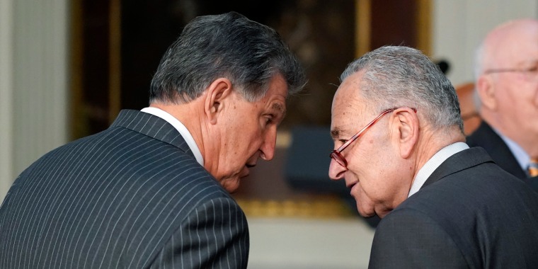 Sen. Joe Manchin, left, talks with Senate Majority Leader Chuck Schumer in the Eisenhower Executive Office Building on the White House Campus in Washington, D.C. on Mar. 15, 2022.