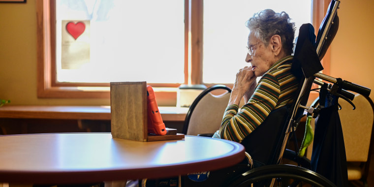 Image: Betty Frost, 96, chats with her family using a tablet at a nursing home in Loveland, Colo. on March 8, 2022.