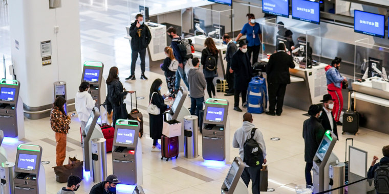 Travelers wait to check-in for their flights at LaGuardia Airport, in New York, on Nov. 25, 2020.