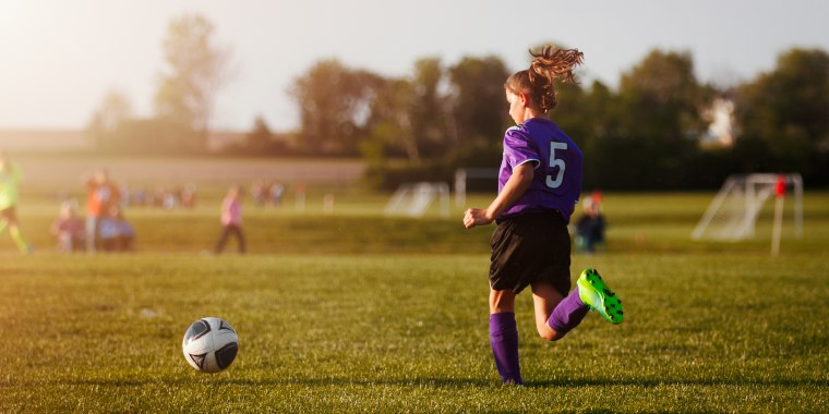 girl playing in soccer game