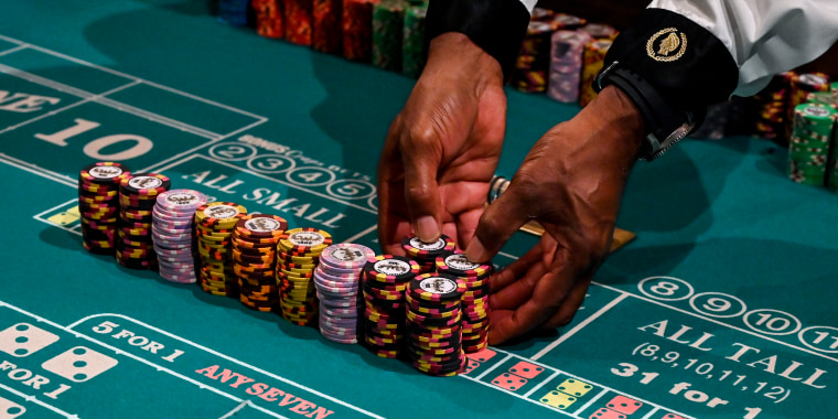 A craps dealer prepares stacks of chips at Caesars Palace on the Las Vegas Strip on June 4, 2020.