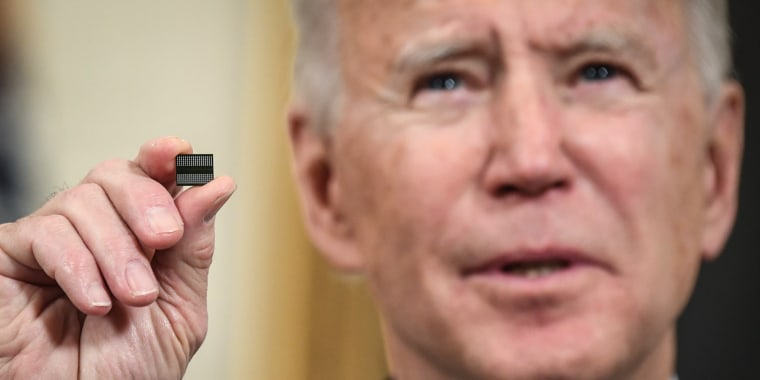 President Joe Biden holds a microchip at the White House in on Feb. 24, 2021.