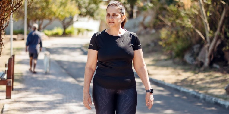 mature woman walking for wellness outdoors