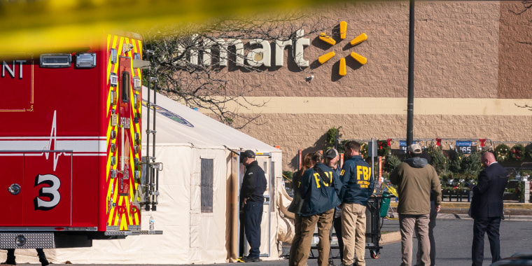 Members of the FBI and other law enforcement investigate the site of a fatal shooting in a Walmart  in Chesapeake, Va.