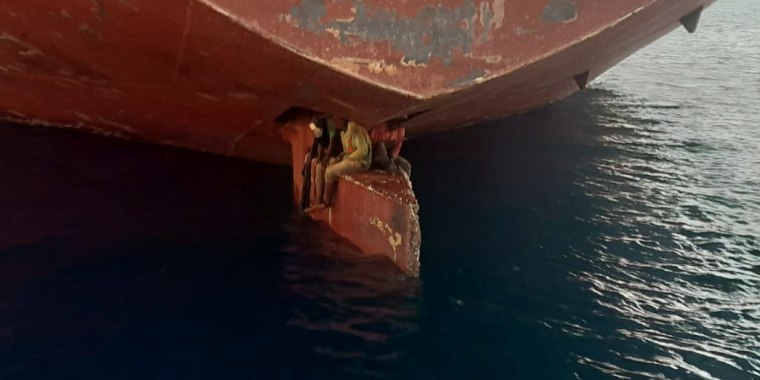 Three African migrants found sitting on the rudder on ship were rescued by the Spanish coastguard in the Canary Islands.